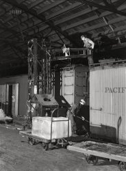 December 1942. "Chicago, Illinois. Icing a refrigerator car in the freight house at a Chicago & North Western railyard." Photo by Jack Delano for the Office of War Information. View full size.