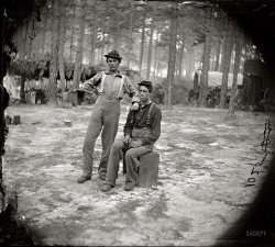 August 1864. "Petersburg, Virginia. Army of the Potomac. Two youthful military telegraph operators at headquarters." Habitues of the Victorian Internet. Wet plate negative, half of stereograph pair, by Timothy H. O'Sullivan. View full size.