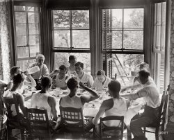 Syracuse freshmen on the rowing team sit around the dinner table on June 19, 1908. View full size. George Grantham Bain Collection.