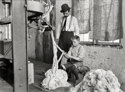 December 1908. "Boy at warping machine, Catawba Cotton Mill. Newton, North Carolina." Glass negative by Lewis Wickes Hine. View full size.