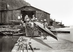 1914. "Syracuse Varsity crew team at boathouse." Bain News Service glass negative. View full size.