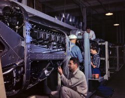 October 1942. Inglewood, California. "Employees at North American Aviation, Incorporated, assembling the cowling on Allison motors for the P-51 'Mustang' fighter planes." 4x5 inch Kodachrome transparency by Alfred Palmer for the Office of War Information. View full size.