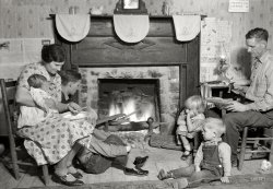 November 1933. "Family group of Fletcher Carden, Route 1, Andersonville, Tennessee. A night-watchman at the Norris Dam bunkhouses. His home is on the townsite of Norris and will be moved. Carden has 12 children. He is shown here repairing shoes at the fireside." Photo by Lewis Wickes Hine. View full size.
