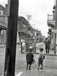 Bourbon Street and Ursulines Avenue circa 1924. "New Orleans organ grinder." Nitrate negative by Arnold Genthe. View full size.
