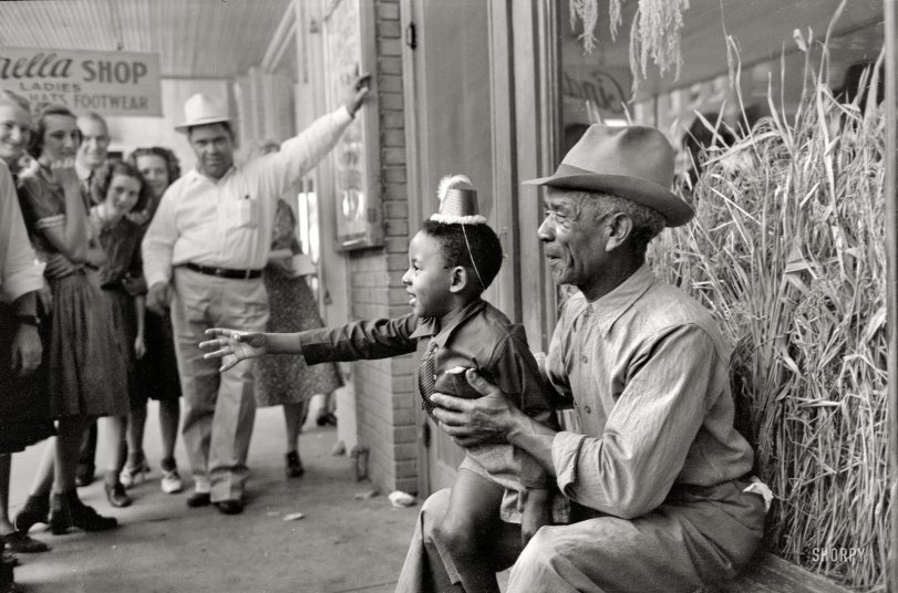 Loves a Parade: 1938 October 1938. "Spectators at National Rice Festival parade in Crowley, Louisiana." 35mm negative by Russell Lee, Farm Security Administration. View full size.