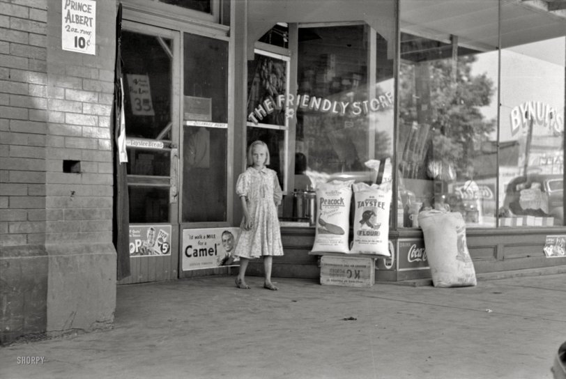 The Friendly Store: 1939 June 1939. "Child coming out of grocery store in Webbers Falls, Oklahoma." 35mm negative by Russell Lee, Farm Security Administration. View full size.