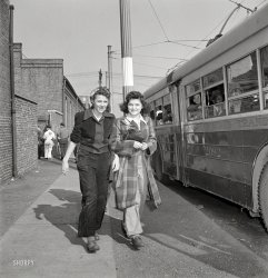 April 1943. "Baltimore, Maryland. Rushing to catch the trackless trolley home from work at 4 p.m." Basically an electric bus. Medium format nitrate negative by Marjory Collins for the Office of War Information. View full size.