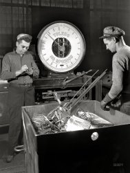 February 1942. "Conversion. Copper and brass processing. Weighing brass scrap. The war program calls for the use of such vast amounts of brass and copper, among other metals, that all available scrap must be utilized. Here a truckload of brass trimmings from a sheet mill is being weighed. From here it will go to the casting shop, where it will be remelted and cast again into billets. Chase Brass and Copper Company, Euclid, Ohio." 4x5 nitrate negative by Alfred Palmer for the Office of War Information. View full size.