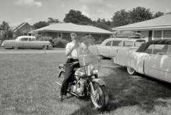 Elvis Presley, at the love-me-tender age of 21 in 1956, at the house he bought for himself and his parents at 1034 Audubon Drive in Memphis. Cadillacs and Harley sold separately. 35mm negative by Phillip Harrington. View full size.