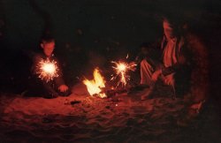 At first glance this might appear to be a photo of a boy playing with sparklers, accompanied by The Mummy. Actually, it's me with my father, who happened to turn his head during this slow exposure. We're on the Russian River beach at Guernewood, California, a couple blocks from our vacation home. Another oddity about this Ektachrome slide by my brother: he was at the height of his camera bug phase, and decided to try developing the film himself, using a Kodak home processing kit, back home in Mother's kitchen sink. I remember the scene, really a mental snapshot of him in the darkened kitchen. This shot, along with others on the roll, exhibit processing anomalies, such as the flurry of red blobs and the aura emanating from the top of my head. The event itself was tons of fun. We semi-successfully shot a rocket over the river, and I remember gleefully watching black snakes curling about on the sand. And the aroma! View full size.