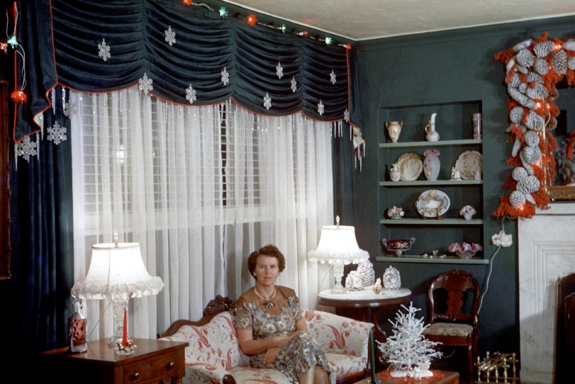 Christmas in Miami: 1954 A holiday chestnut worth reheating over the Shorpy Duraflame.
"Christmas 1954." My grandmother Sarah Hall (1904-2000) in her living room in Miami Shores four years before I was born. She made the mantel decoration, which saw service for many years, with Brazilian pepper berries from a big tree in the backyard, mixed with pine cones, all attached to a chicken wire frame. Grandmother, handy with a needle and thread, also made the curtains. She was, needless to say, big on Christmas. 35mm Kodachrome. View full size.